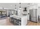 Bright kitchen with an island featuring barstool seating and stainless steel appliances at 8714 E Plaza Ave, Scottsdale, AZ 85250