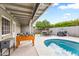 Covered patio with outdoor seating, dining table, foosball table, and a view of the pool at 8714 E Plaza Ave, Scottsdale, AZ 85250