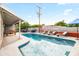 Backyard pool with Scottsdale mural, lounge chairs, dining and foosball game at 8714 E Plaza Ave, Scottsdale, AZ 85250