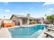 Sparkling backyard pool and hot tub with outdoor seating and mature landscaping at 8714 E Plaza Ave, Scottsdale, AZ 85250