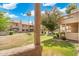 View of the beautiful community landscaping with grass, trees, and flowers at 930 N Mesa Dr # 1045, Mesa, AZ 85201