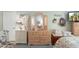 Bedroom with a decorative wooden dresser with a tri-fold mirror and floral accents providing a charming space at 930 N Mesa Dr # 1045, Mesa, AZ 85201