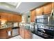 This charming kitchen features stainless steel appliances, granite countertops and warm lighting at 930 N Mesa Dr # 1045, Mesa, AZ 85201
