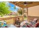 Cozy covered patio with cushioned seating, ceiling fan and views of the well maintained community green space at 930 N Mesa Dr # 1045, Mesa, AZ 85201