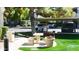 Charming community picnic area with stone table, bench, and grill, set amidst verdant landscaping at 9600 N 96Th St # 267, Scottsdale, AZ 85259