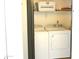 Efficient laundry room equipped with a washer and dryer set, and convenient overhead storage shelves at 9600 N 96Th St # 267, Scottsdale, AZ 85259