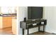 Living room with a wall-mounted TV and modern console table next to the kitchen area at 9600 N 96Th St # 267, Scottsdale, AZ 85259