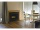 Cozy living room with fireplace and a sunny dining area with a white table and chairs at 9600 N 96Th St # 267, Scottsdale, AZ 85259