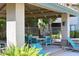 Resort-style pool area featuring shaded seating, lounge chairs, and lush tropical landscaping at 9600 N 96Th St # 267, Scottsdale, AZ 85259