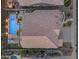 Aerial view of a beautiful backyard with a sparkling pool, spa, and green spaces at 9702 E Naranja Ave, Mesa, AZ 85209