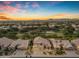 Beautiful aerial view of a home and neighborhood during sunset with lush landscaping and mountain views at 9702 E Naranja Ave, Mesa, AZ 85209