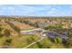This aerial showcases a community golf course, lush landscaping, and inviting ponds at 9702 E Naranja Ave, Mesa, AZ 85209