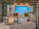 Aerial view showcases the backyard with a pool, spa, putting green, and outdoor kitchen at 9702 E Naranja Ave, Mesa, AZ 85209