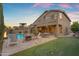 Spacious backyard featuring a pool, spa, patio, putting green, and outdoor seating area at 9702 E Naranja Ave, Mesa, AZ 85209