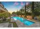Outdoor living is perfected in this yard with a pool, spa, fire features, and elegant landscaping at 9702 E Naranja Ave, Mesa, AZ 85209