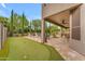Entertainer's backyard features a putting green, covered patio, and a sparkling pool for ultimate relaxation at 9702 E Naranja Ave, Mesa, AZ 85209