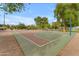 Community basketball court surrounded by trees and greenery, ideal for recreation and outdoor activities at 9702 E Naranja Ave, Mesa, AZ 85209