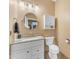 Powder room with granite vanity and white fixtures at 9702 E Naranja Ave, Mesa, AZ 85209