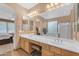 Primary bathroom with double sinks, tub, separate shower and backyard view at 9702 E Naranja Ave, Mesa, AZ 85209