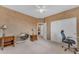 Bedroom with a ceiling fan, closet, and furnishings that include a decorative mirror at 9702 E Naranja Ave, Mesa, AZ 85209