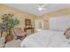 A cozy, well lit bedroom with a bed, seating, and ample space at 9702 E Naranja Ave, Mesa, AZ 85209