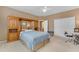 A warm Primary bedroom with a built-in headboard and lots of closet space at 9702 E Naranja Ave, Mesa, AZ 85209