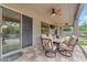 Inviting covered patio featuring a cozy dining set, ceiling fans, and sliding glass doors to the home's interior at 9702 E Naranja Ave, Mesa, AZ 85209