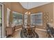 Cozy dining area with bay windows and chandelier offers a bright and inviting space at 9702 E Naranja Ave, Mesa, AZ 85209