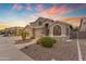 Stunning home featuring manicured desert landscaping, a three-car garage, and a grand entrance at 9702 E Naranja Ave, Mesa, AZ 85209