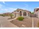 A large two-story home with a three car garage, manicured front yard, and neutral colors at 9702 E Naranja Ave, Mesa, AZ 85209