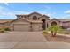 A two-story home with a three car garage, desert landscaping, and neutral colors at 9702 E Naranja Ave, Mesa, AZ 85209