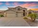Elegant two-story home featuring a three-car garage and desert landscaping at 9702 E Naranja Ave, Mesa, AZ 85209
