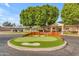 Augusta Ranch Golf Club entrance featuring a putting green and the clubhouse in the background at 9702 E Naranja Ave, Mesa, AZ 85209
