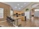 Well-lit kitchen with an island, granite countertops, a breakfast bar, and modern appliances at 9702 E Naranja Ave, Mesa, AZ 85209