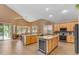 Gourmet kitchen features hardwood floors, a large kitchen island, stainless steel appliances, and ample counter space at 9702 E Naranja Ave, Mesa, AZ 85209