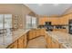 Bright, modern kitchen featuring granite counters, stainless steel appliances, and hardwood flooring at 9702 E Naranja Ave, Mesa, AZ 85209