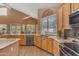 Open kitchen includes granite countertops, stainless appliances and spacious layout perfect for entertaining at 9702 E Naranja Ave, Mesa, AZ 85209