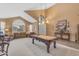Bright living room featuring a billiards table, comfortable seating, and stylish decor at 9702 E Naranja Ave, Mesa, AZ 85209
