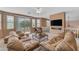 Spacious living room featuring comfortable seating, ceiling fan and access to the patio at 9702 E Naranja Ave, Mesa, AZ 85209