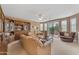 Spacious living room featuring built-in shelving and a sliding glass door to patio at 9702 E Naranja Ave, Mesa, AZ 85209