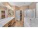 Bright bathroom with double sinks, separate shower, tub and walk-in closet at 9702 E Naranja Ave, Mesa, AZ 85209