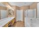 Bright bathroom with double sinks, separate shower, tub and walk-in closet at 9702 E Naranja Ave, Mesa, AZ 85209