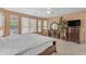 Bright and airy bedroom featuring large windows and a dark wooden dresser with a mirror at 9702 E Naranja Ave, Mesa, AZ 85209