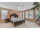 Large bedroom with neutral walls, ceiling fan and large windows to let in lots of light at 9702 E Naranja Ave, Mesa, AZ 85209