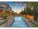 Resort-style pool area with fire bowls, lush landscaping, and comfortable lounge seating at 9702 E Naranja Ave, Mesa, AZ 85209