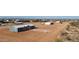 Aerial view of a new home in a rural neighborhood with a 'For Sale' sign at 10150 E Shallow Canyon Rd, San Tan Valley, AZ 85143