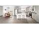 Open kitchen with island, stainless steel appliances, and adjacent dining area at 10150 E Shallow Canyon Rd, San Tan Valley, AZ 85143