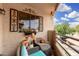 Cozy balcony with seating area, decorative window, stucco wall and wrought iron railing at 10301 N 70Th St # 223, Paradise Valley, AZ 85253