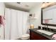 Bright bathroom featuring a granite vanity, framed mirror, and shower with a white waffle weave curtain at 10301 N 70Th St # 223, Paradise Valley, AZ 85253