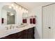 Bright bathroom featuring dual sinks, marble countertops, and elegant gold fixtures at 10301 N 70Th St # 223, Paradise Valley, AZ 85253